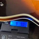 Used 1979 Gretsch 7682 Atkins Super Axe Sunburst on scale displaying weight.
