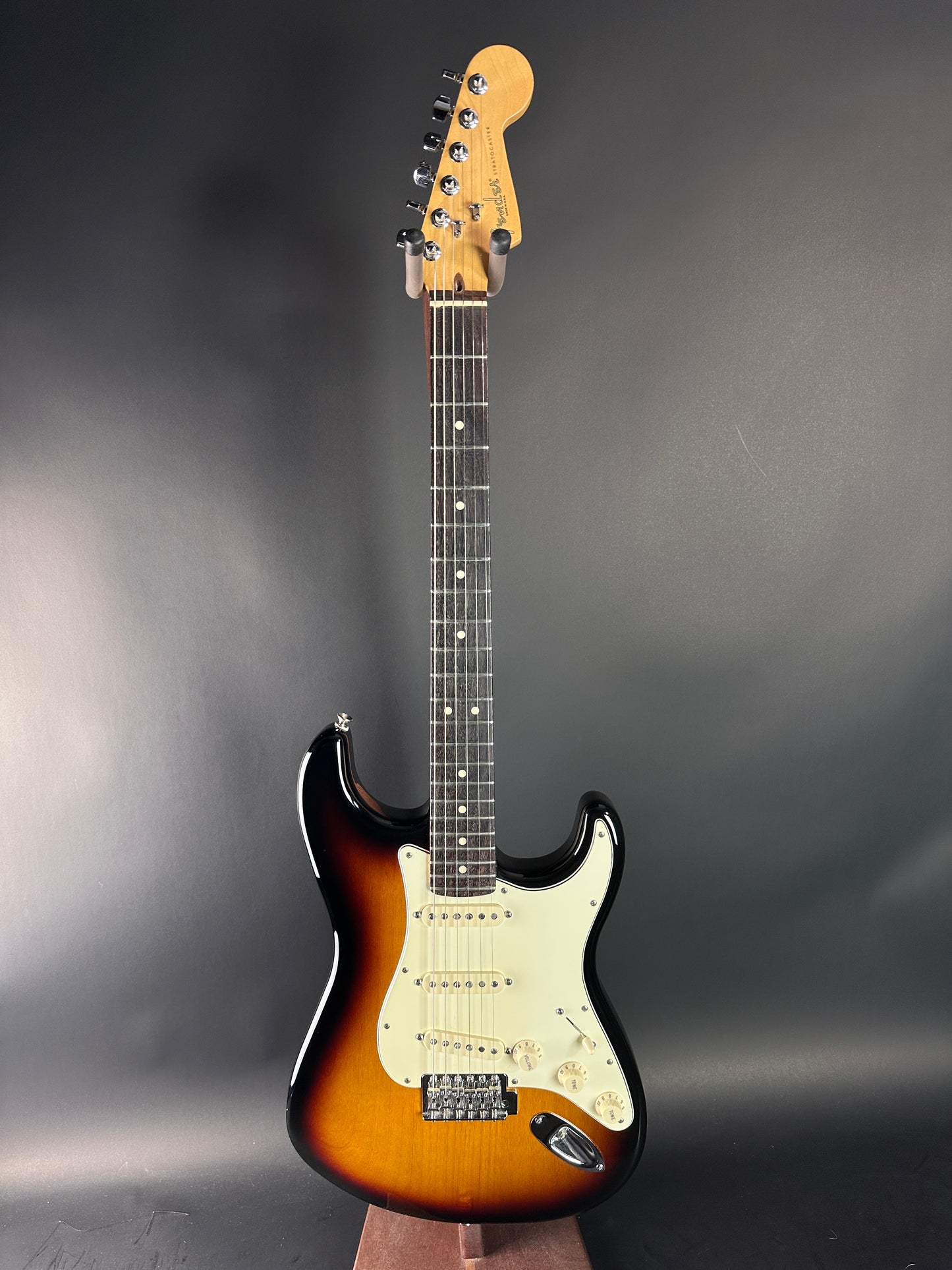 Electric guitar with a sunburst finish on a gray background