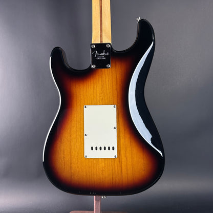 Fender electric guitar with sunburst finish on a gray background