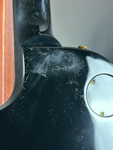 Close-up of a guitar with visible wear and tear on the slide.