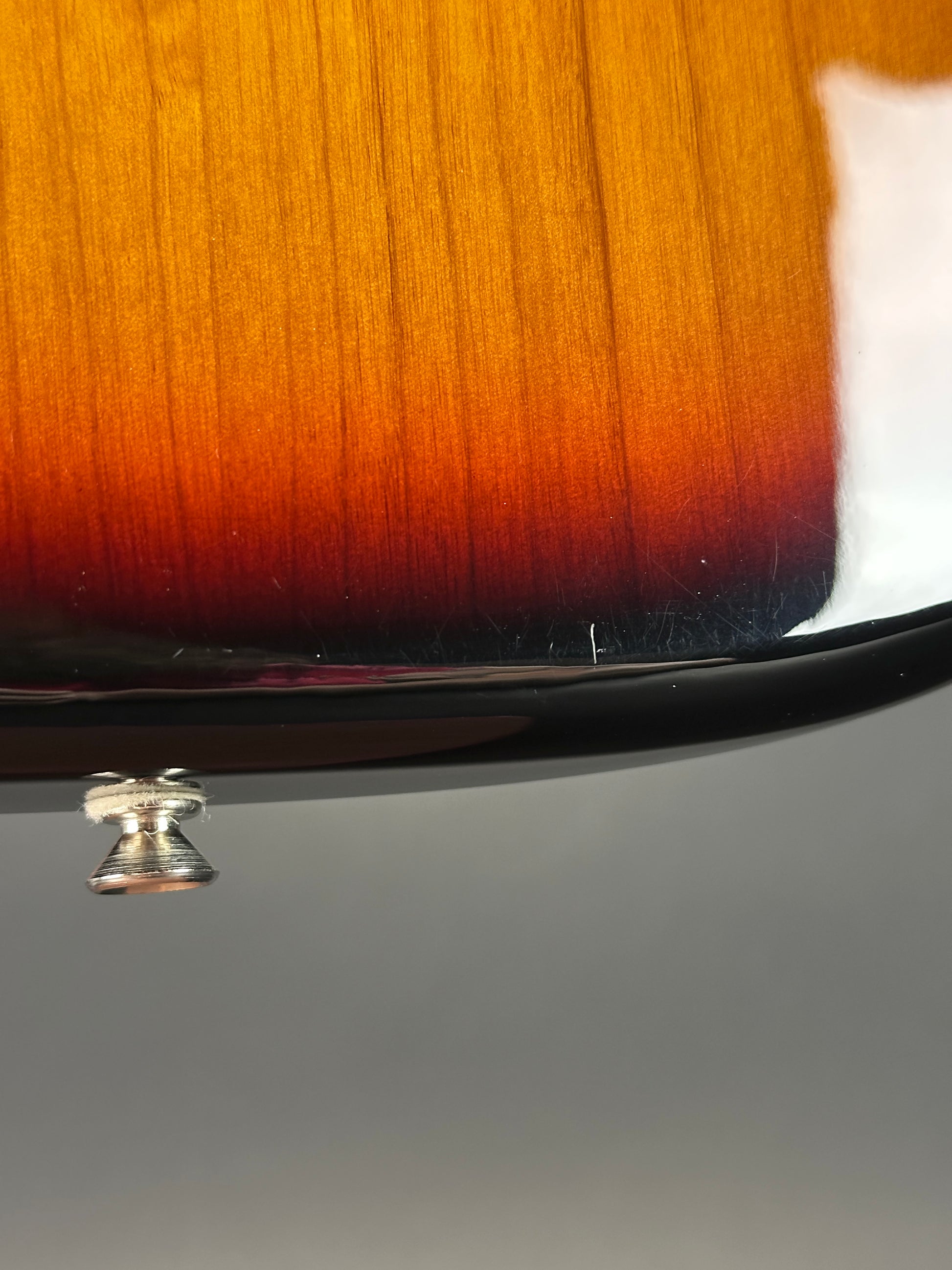 Wear on bottom edge of Used 2000 Fender American Standard Stratocaster Sunburst.
