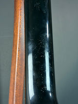 Close-up of a black object with a reflective surface on a gray background