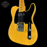 Yellow electric guitar on a black background with 'Tone Shop' logo.