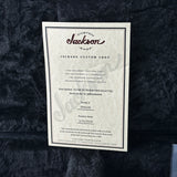 Jackson guitar certificate on a textured black background