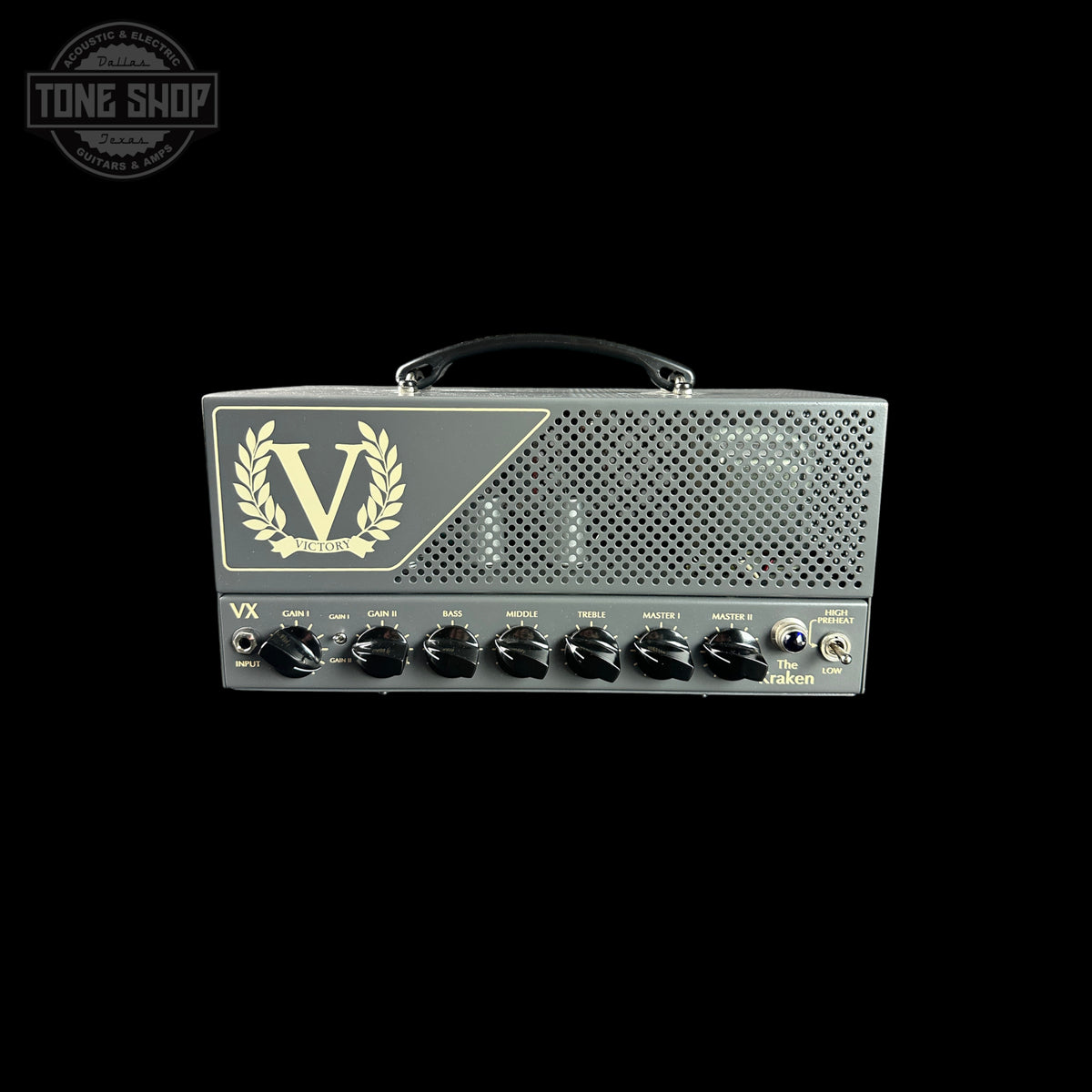 A Victory VX guitar amplifier head in dark gray metal with gold logo detailing and black control knobs, shown against a solid black background.