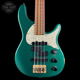 Green electric bass guitar with a white pickguard on a black background, featuring the Tone Shop logo.