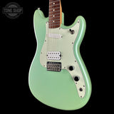 A mint green electric guitar with a white pickguard and silver hardware, shown against a solid black background. A Tone Shop watermark is visible in the top-left corner.