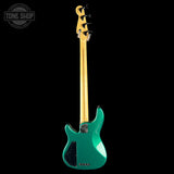 Green electric bass guitar with a black pickguard on a white background, featuring the Tone Shop logo.