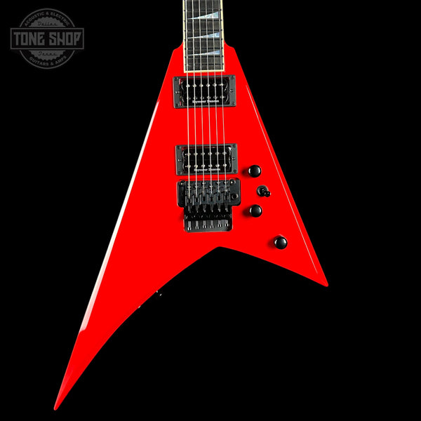 Red electric guitar with a black background