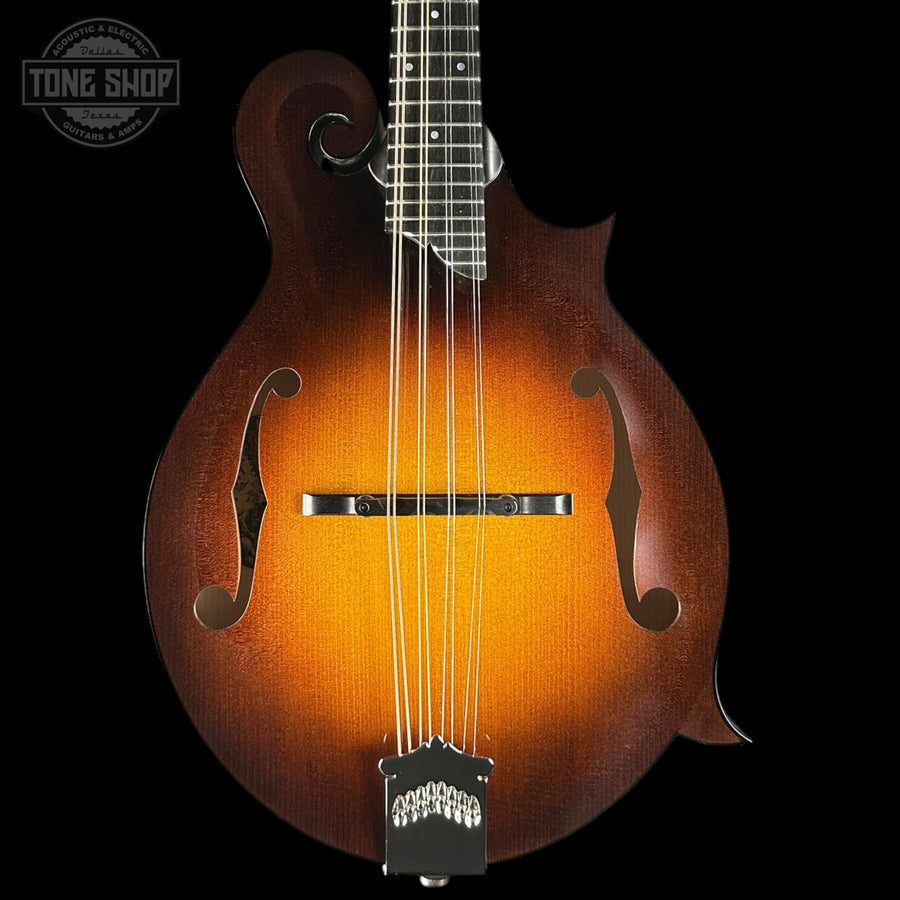 Fretless mandolin with a dark brown finish on a black background, featuring the Tone Shop logo.