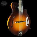 Mandolin with a dark brown finish on a black background, featuring the Tone Shop logo.