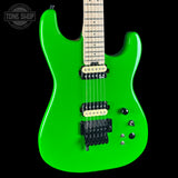 Green electric guitar with a black pickguard on a black background, featuring the Tone Shop logo.