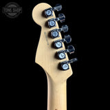 Guitar headstock with tuning pegs on a black background, featuring 'Tone Shop' branding.