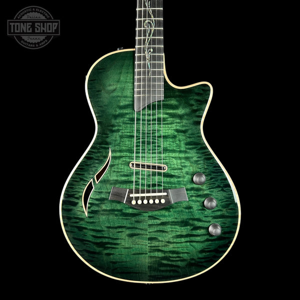 Green electric guitar with a quilted finish on a black background, featuring the Tone Shop logo.