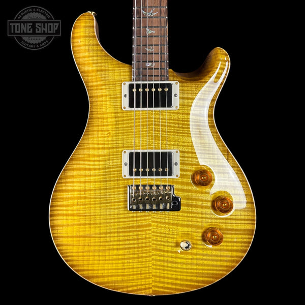 Electric guitar with a sunburst finish on a black background, featuring the Tone Shop logo.