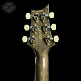 Guitar headstock with tuning pegs on a black background, featuring 'Tone Shop' branding.
