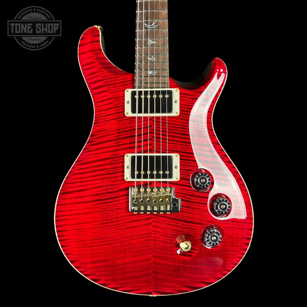 Red electric guitar with a black background, featuring the Tone Shop logo.