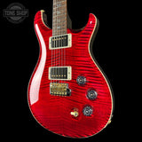 Red electric guitar with a black background