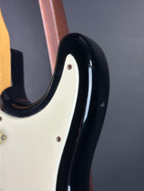 Close-up of a guitar's pickguard with a black and white design.