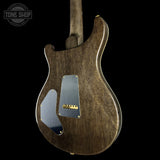 Wooden electric guitar body with a visible brand logo on a black background