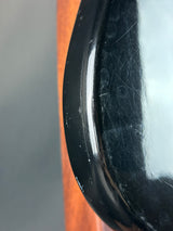 Close-up of a black rim with visible scratches on a vehicle.