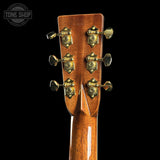 Close-up of a guitar headstock with tuning pegs on a black background, featuring 'Tone Shop' branding.