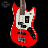 Red electric bass guitar with a white pickguard on a black background, featuring the Fender logo.