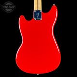 Red electric guitar with a visible brand logo on a black background