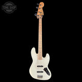 White electric bass guitar with a maple neck on a black background, featuring the Tone Shop logo.