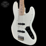White electric bass guitar with a black pickguard on a white background, featuring the Tone Shop logo.