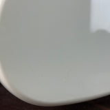 Close-up of a white object with visible texture on a dark surface