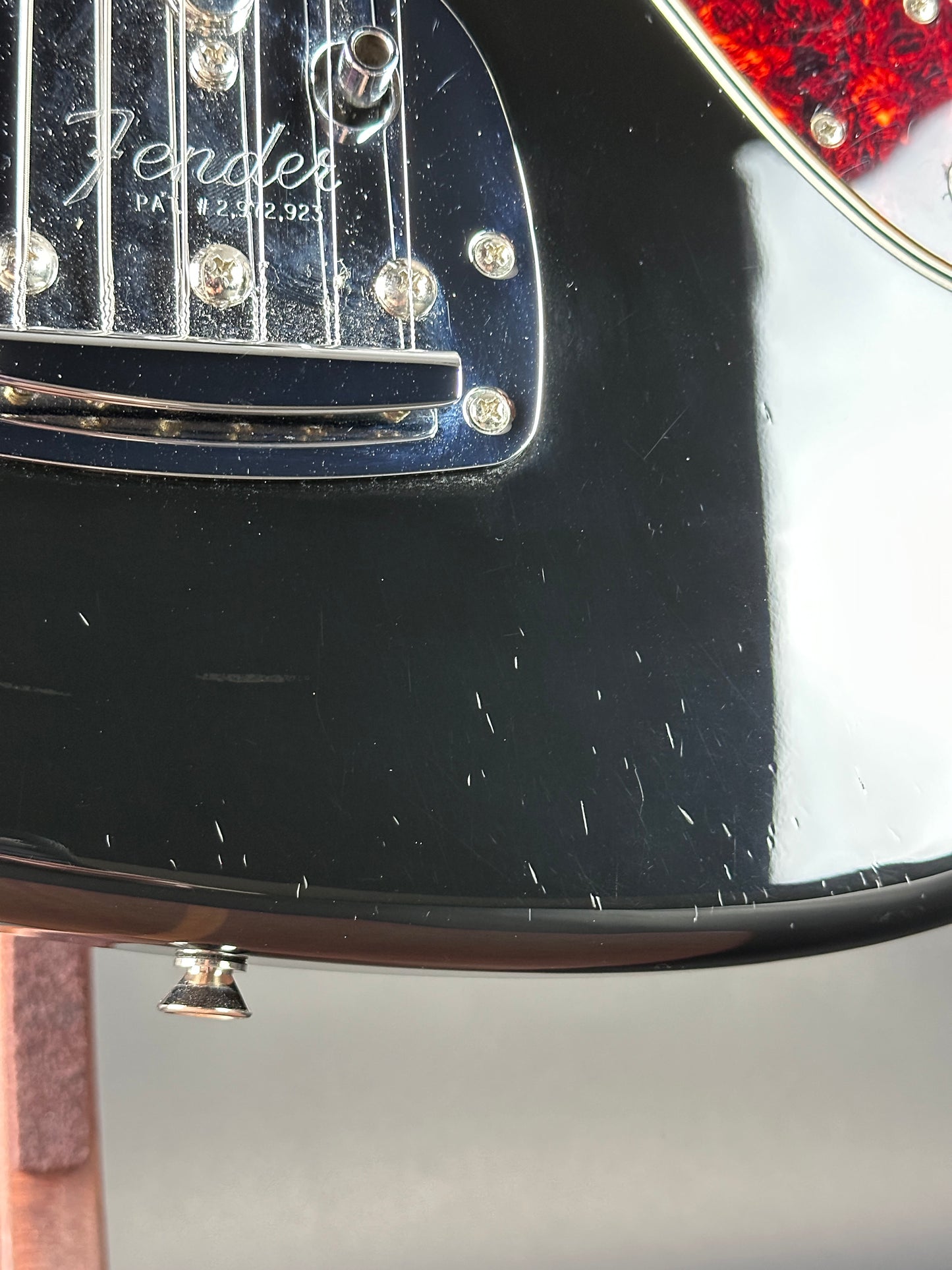 Close-up of a Fender guitar headstock with a blurred background