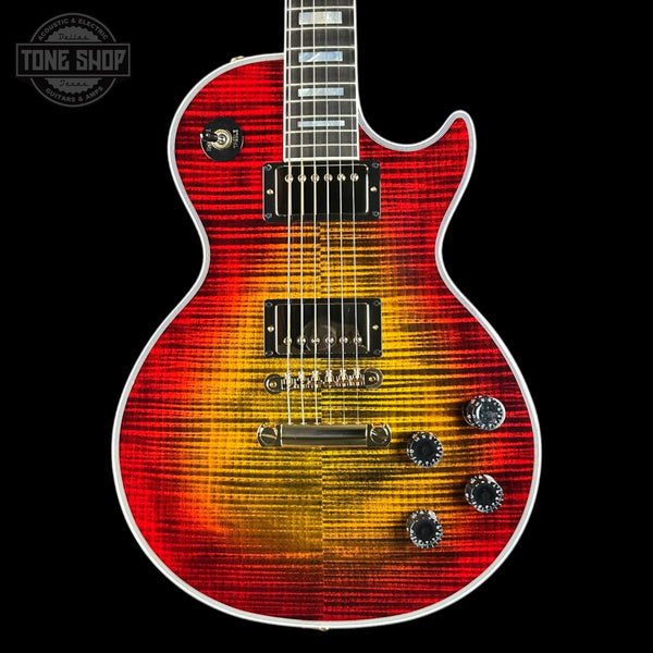 Electric guitar with a red and orange flame pattern on a black background, featuring the 'Tone Shop' logo.