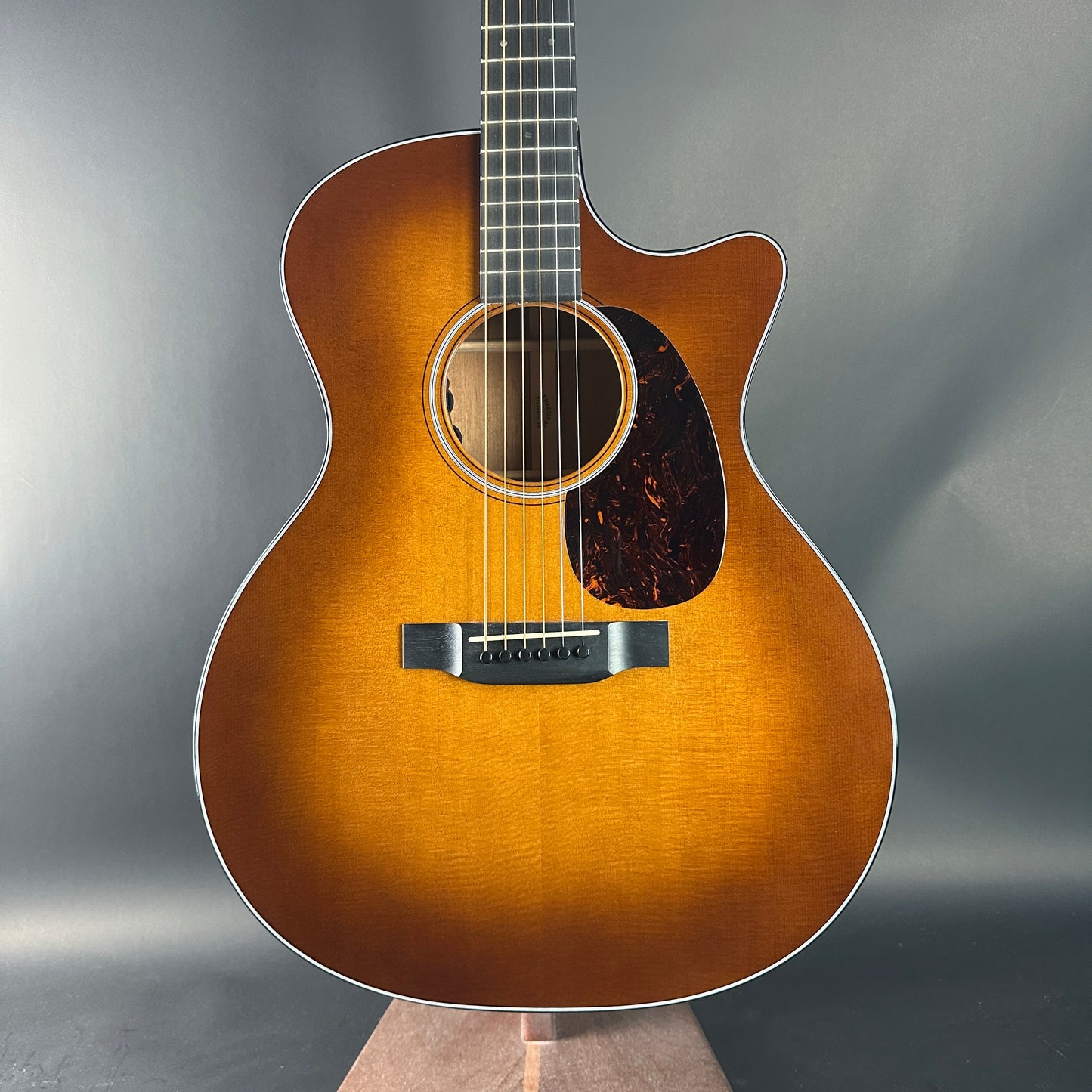 Acoustic guitar with a sunburst finish on a gray background