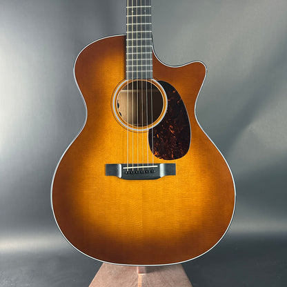 Acoustic guitar with a sunburst finish on a gray background