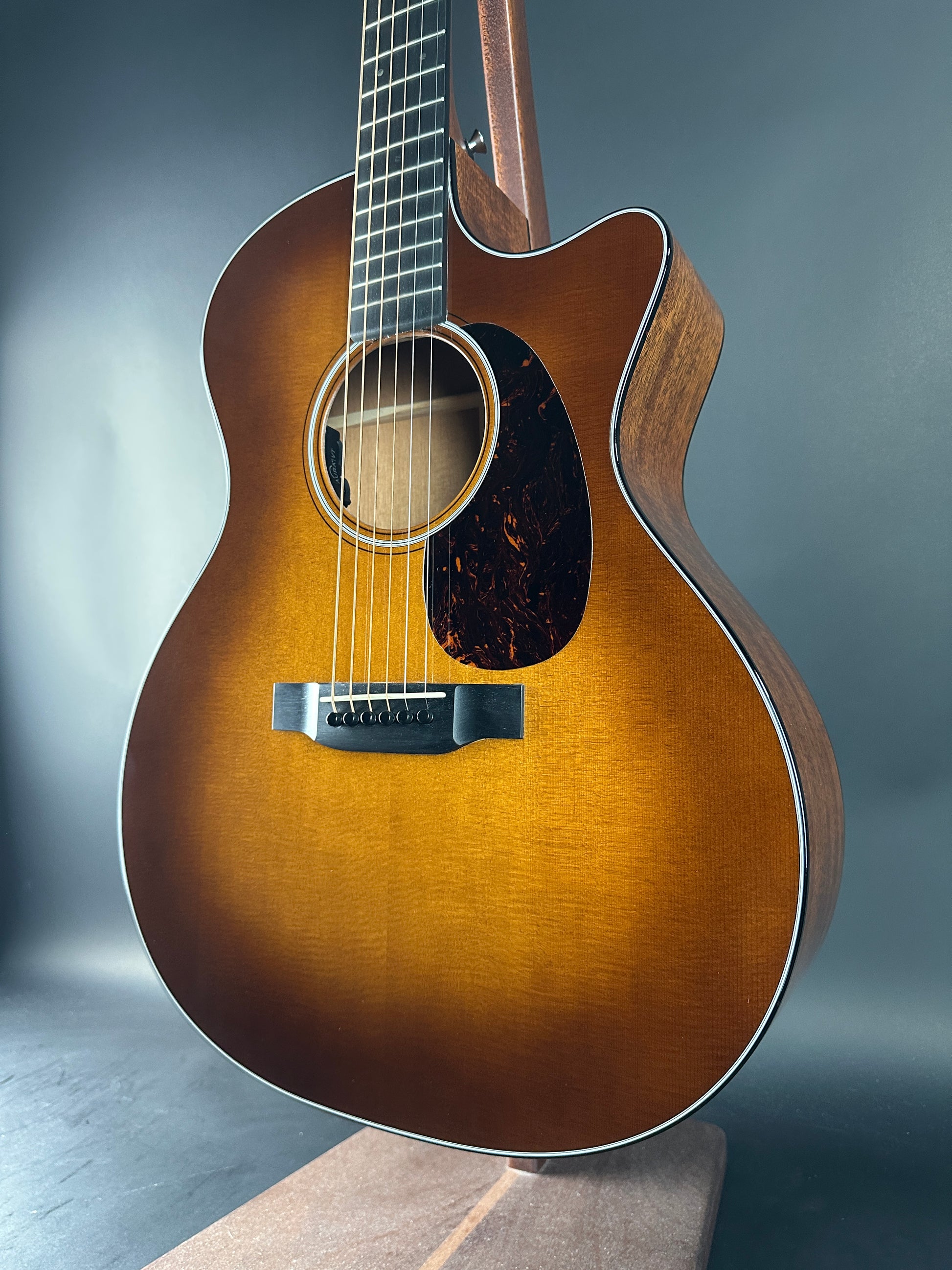 Acoustic guitar with a sunburst finish on a gray background