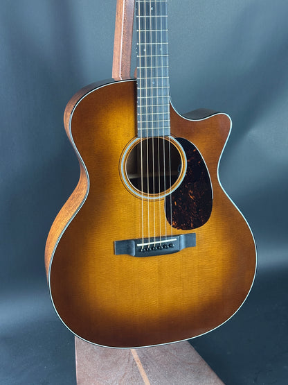 Acoustic guitar with a sunburst finish on a dark background