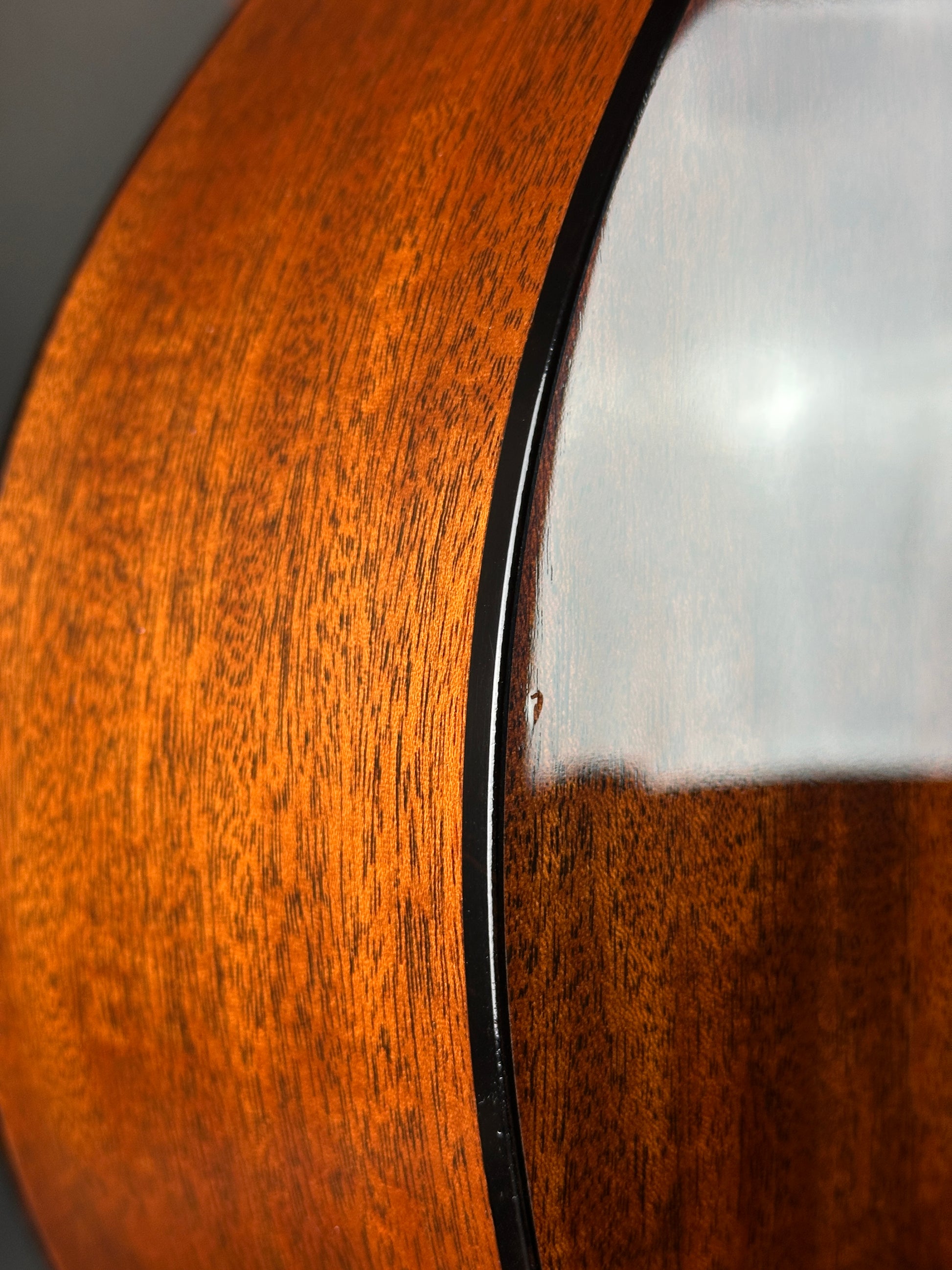 Close-up of a wooden surface with a metallic rim
