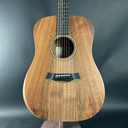 Acoustic guitar with a wooden finish on a dark gray background
