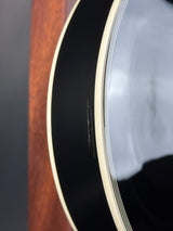 Close-up of an acoustic guitar's soundhole with a clear cover.