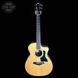 A natural wood cutaway acoustic-electric guitar shown from the front against a solid black background, with a Tone Shop watermark in the top-left corner.
