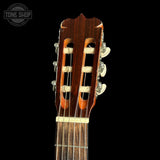 Close-up of a guitar headstock with a dark background