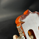 Close-up of a guitar's soundhole with a dark background