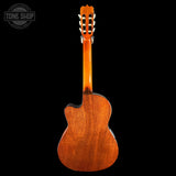 Back view of a wooden acoustic guitar with 'Tone Shop' logo in the corner.