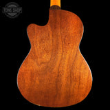 Back view of a wooden acoustic guitar with 'Tone Shop' logo in the corner.