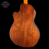 Back view of a wooden acoustic guitar with 'Tone Shop' logo in the corner.