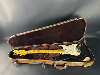 Electric guitar in an open case on a gray background