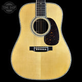 Acoustic guitar with a visible brand logo in the corner
