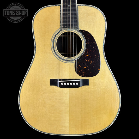 Acoustic guitar with a visible brand logo in the corner