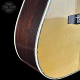 Close-up of a guitar with a visible brand logo in the corner.
